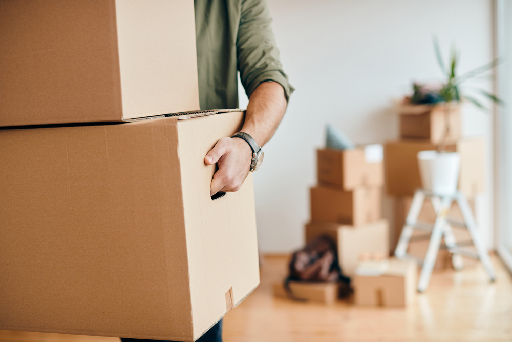 close up,of,a,man,with,carton,boxes,moving,into,new